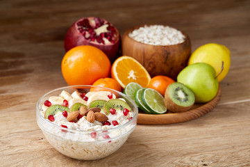 Breakfast still life with oatmeal porridge and fruits, top view, selective focus, shallow depth of field.