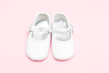 Shoes for the little girl of white color on pastel background. Fashion