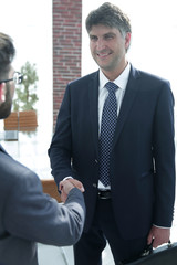 Handshake of a businessman and a lawyer in the office