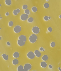 Detalle de huecos de rebanada de queso emmental.