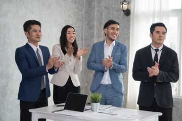  Businessman and woman applauding for success deal