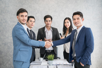 Businessman checking hand to success deal and agreement while another people applauding. Concept for Work, Meeting, Presentation, Coaching
