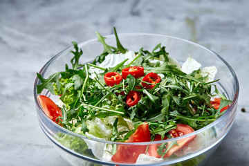 Dietary mixed salad in glass sultana on white textured background, selective focus, vertical