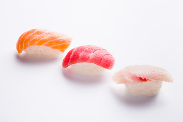 Three colorful sushi in a row on white background