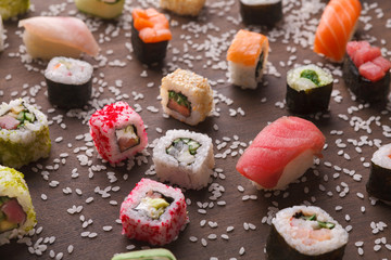 Assortment of colorful sushi and rolls background