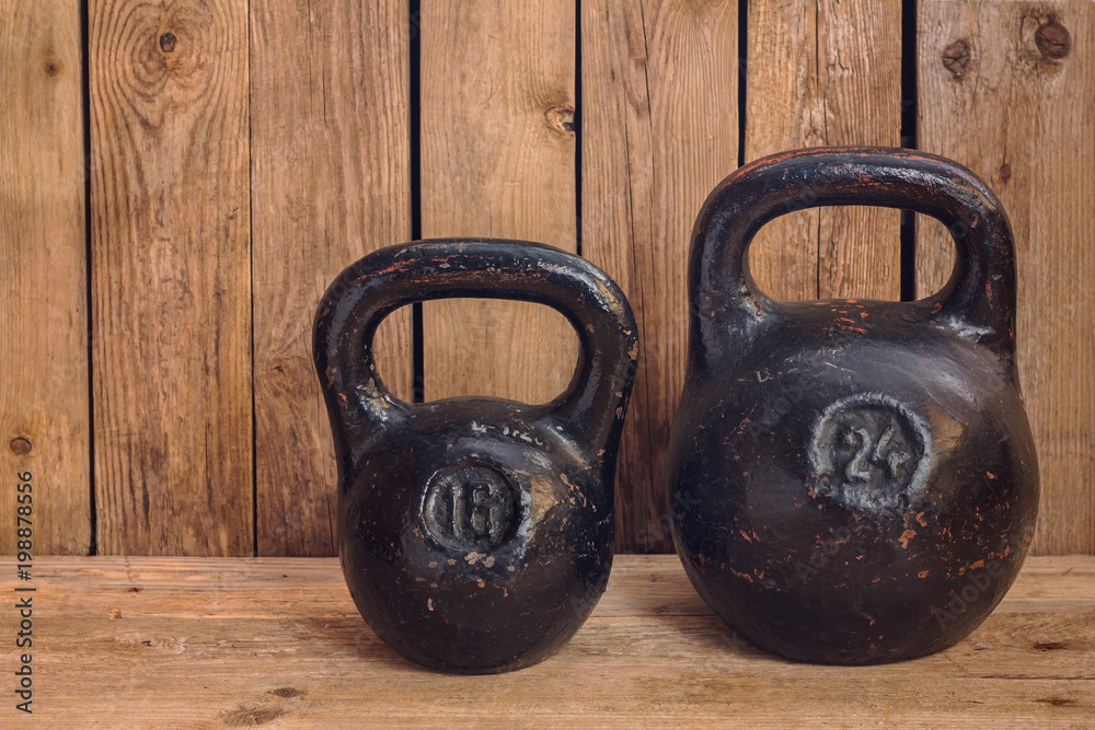 Wall mural pair of two old heavy iron kettlebells