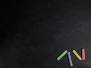 Colored crayons on a blackboard.