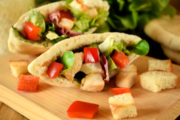 Caesar salad in pita bread on a wooden board