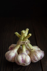 Garlic heads on dark wooden table