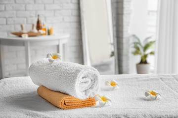 Towels on massage table in spa salon