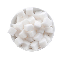 Refined sugar cubes in bowl on white background, top view