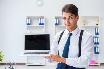 Young stylish businessman working in the office