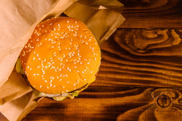Fresh hamburger on the rustic wooden table. Top view