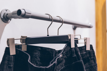 man jeans on hanger in store. fashion shopping clothes