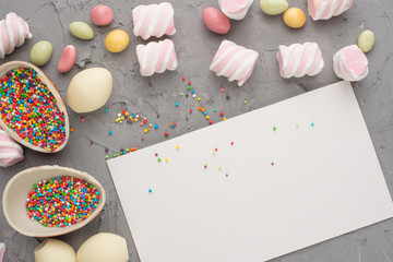 Chocolate easter eggs with a colored dragee. A top view, on a colored background, with an empty space for inscription or advertising.