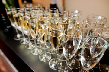 Set of elegant glasses filled with champagne