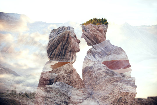 Double exposure man and woman couple hugging with mountains in background. Mountains inside couple in love. Lovers look at each other, tender feelings and love, superimposition of two frames