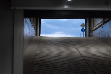 Tunnel of underground parking. Blue sky at the end of the exit. the concept of a way out of a difficult situation
