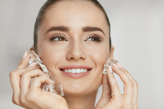 Beauty Treatment. Woman With Ice Cubes