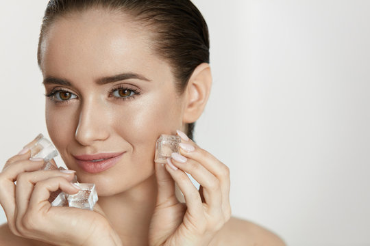 Ice On Skin. Woman Doing Face Skin Treatment