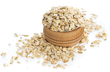 Oat flakes in wooden bowl isolated on white background