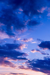 Obraz premium Vivid color clouds on sunset landscape. Blue sky with bright pink, yellow and purple