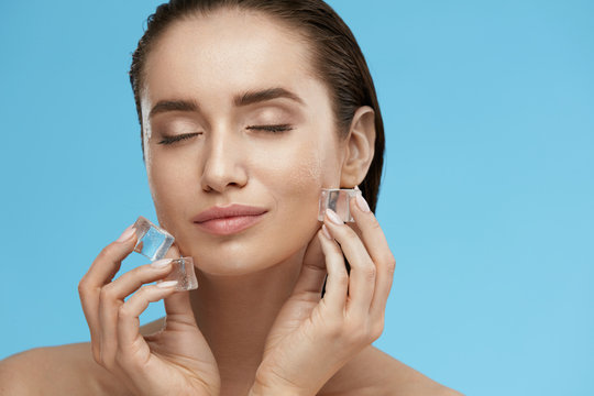 Face Skin Care. Woman Applying Ice Cubes