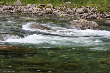 streaming water in the river with rocks