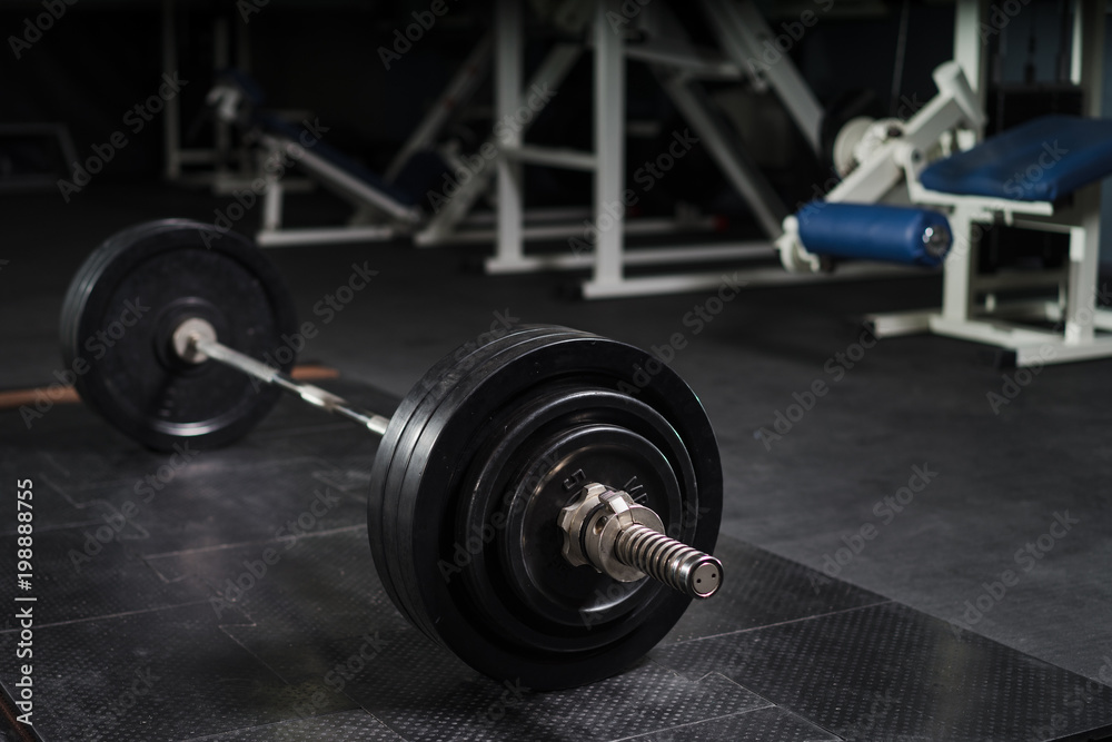 Wall mural fitness equipment in a cross-training gym. barbell lying on the mat. powerlifting, weightlifting, de