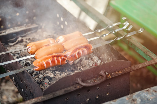 Delicious, juicy sausages, grilled on skewers over an open fire.