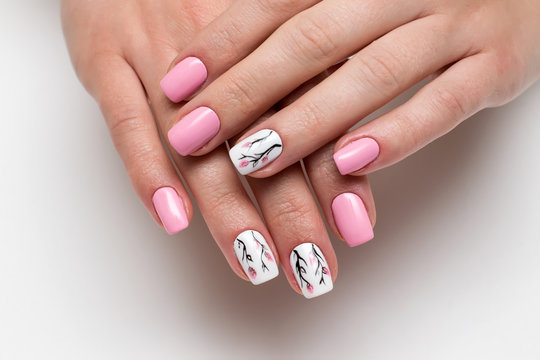 delicate pink manicure with spring flowers on short square nails on a white background