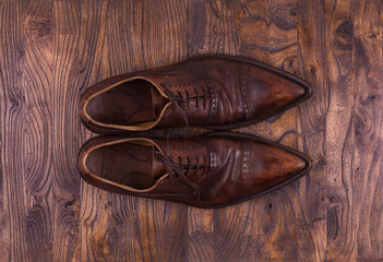 old leather brown shoes on the wooden floor