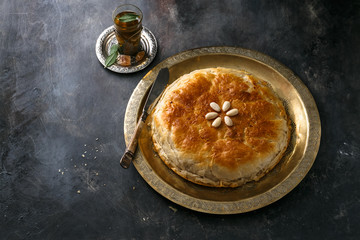 Moroccan bastilla on copper palte, space for wording