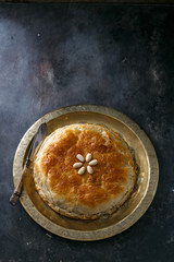 Moroccan bastilla on copper palte, space for wording