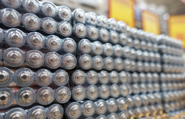 Electric batteries size AAA AA lot of gray in the package in the store. Shallow depth of field