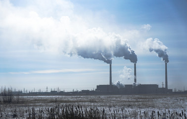Air pollution by smoke coming out of factory chimneys.