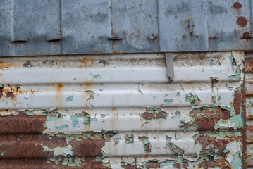 corrugated iron surface is covered with old paint, chipped paint, texture background