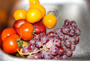Washed vegetables. Vegetables under the running water in the sink. Fresh vegetables close-up.