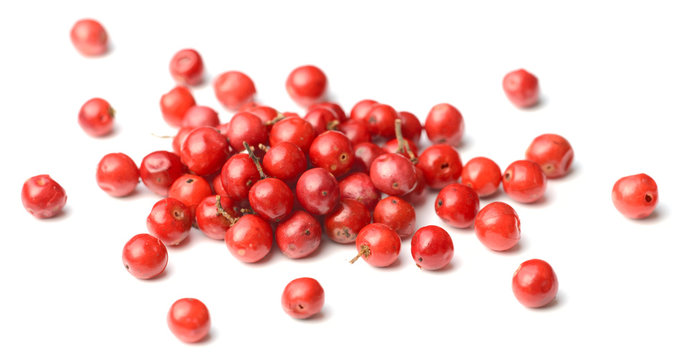 closeup of dried pink peppercorns isolated on white