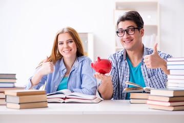 Two students checking savings to pay for education