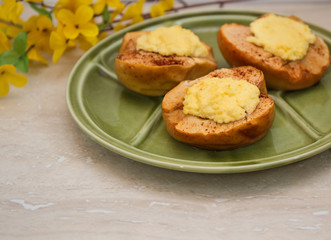 baked apples with cottage cheese on green plate.