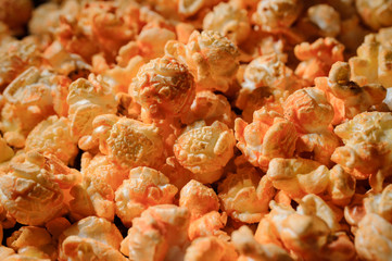 grains of yellow roasted popcorn are photographed close up
