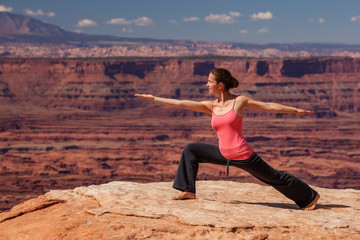 Woman meditating doing yoga in Canyonlands National park in Utah, USA