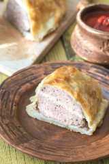 Portion of beef Wellington with tomato sauce