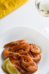 shrimps with a glass of wine on a white background