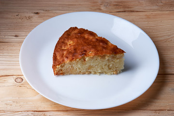 tasty apple pie slice on white plate