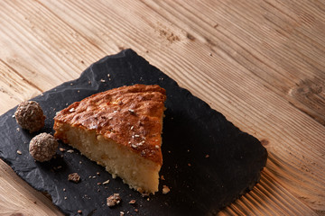 Delicious slice of freshly baked apple pie on shale board