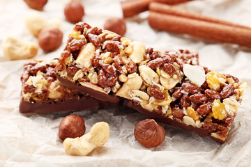 Tasty chocolate granola bars with different nuts