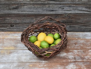 Lemons and limes in a cedar basket