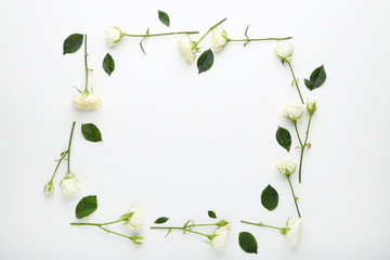 Fototapeta na wymiar Rose flowers with green leafs on white background